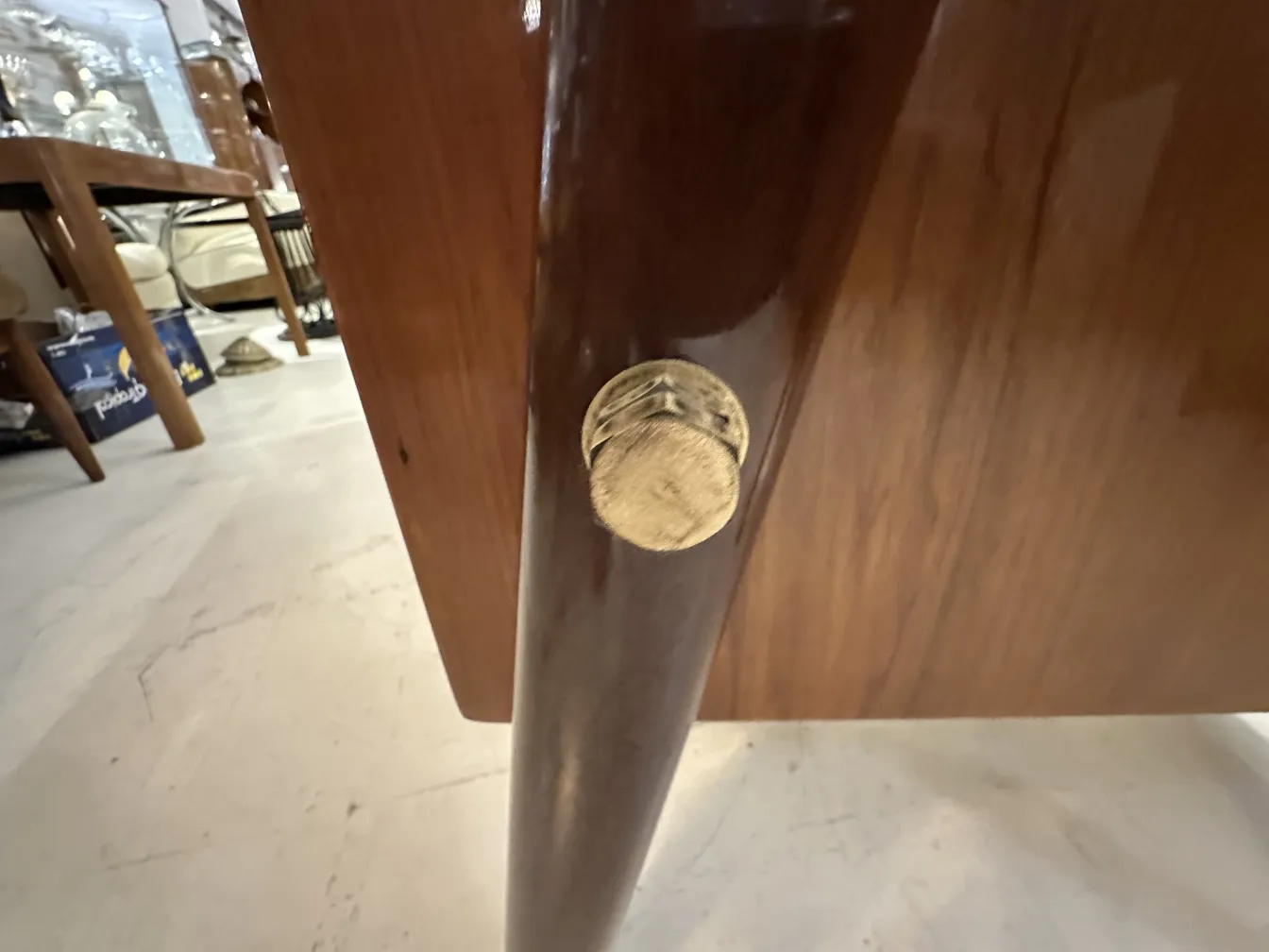 Detail of the golden leg of an antique desk in a cozy setting