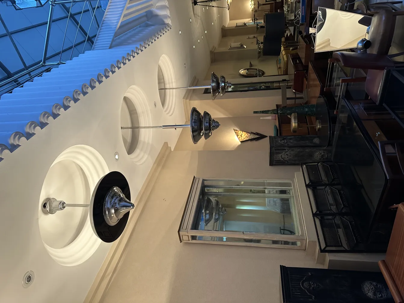 Antique hanging lamp, elegant in a decorative setting. Various furniture around.