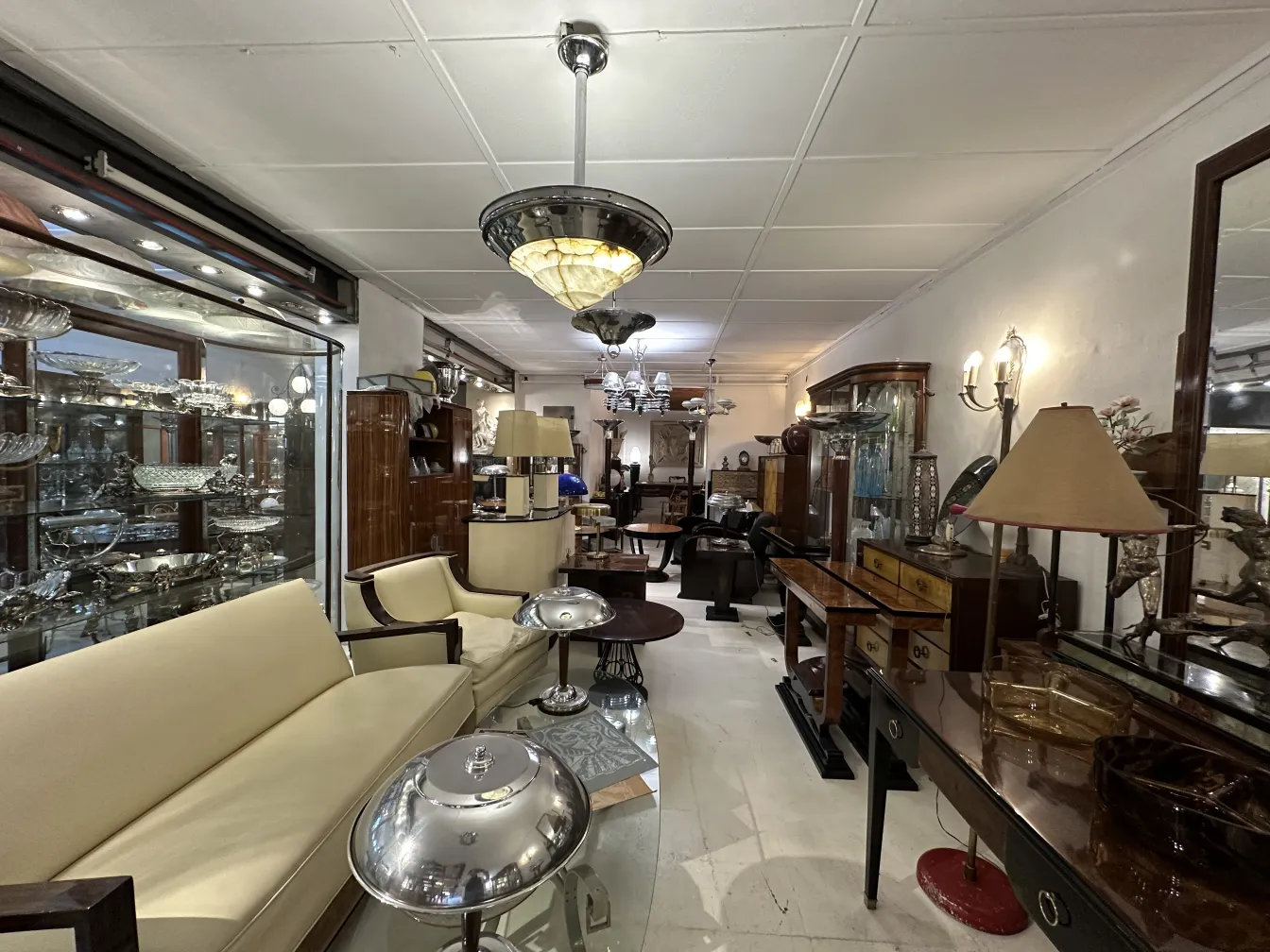 Antique hanging lamp surrounded by classic furniture in a store