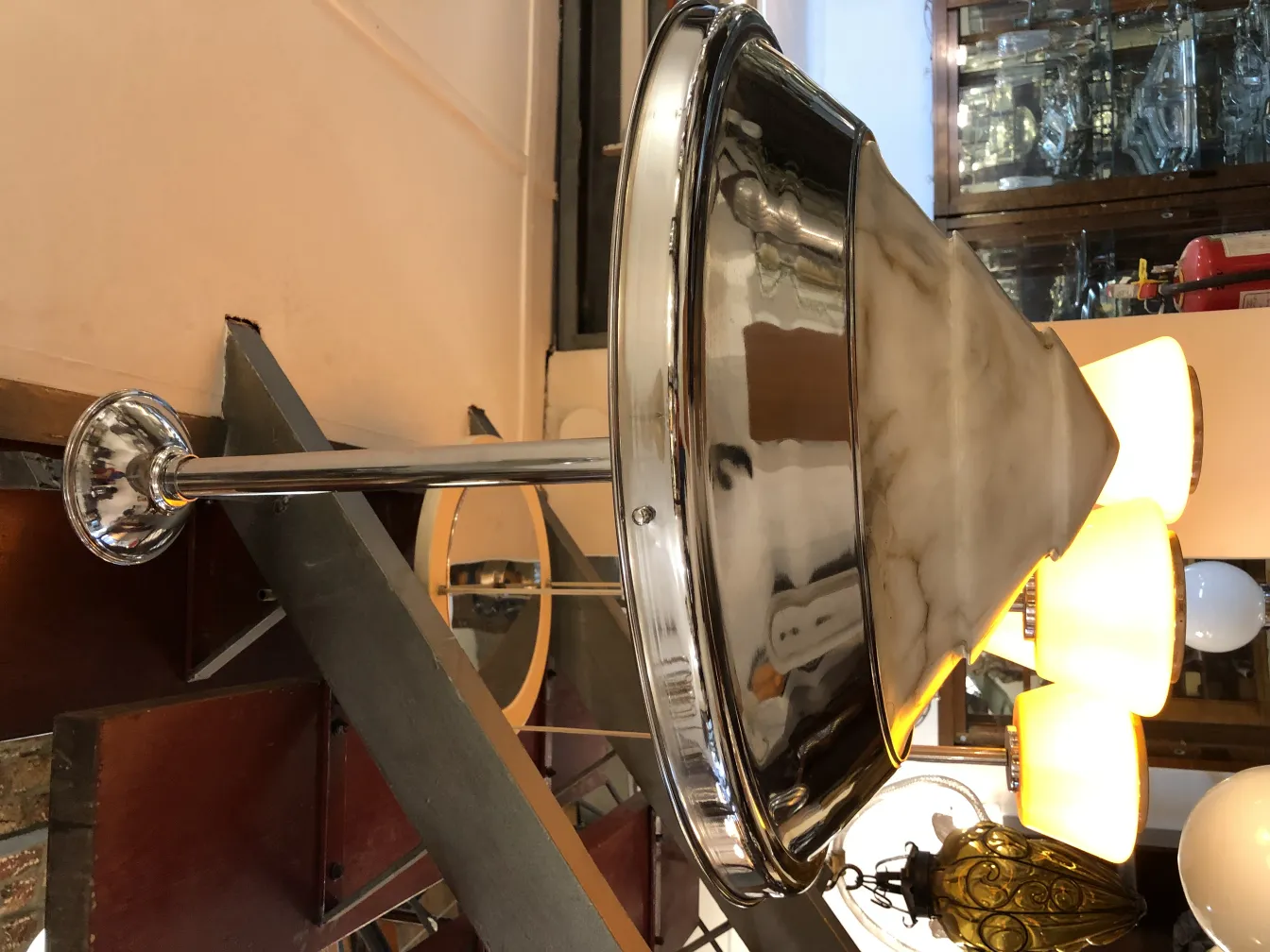 Antique hanging lamp with marble shade in a charming setting.