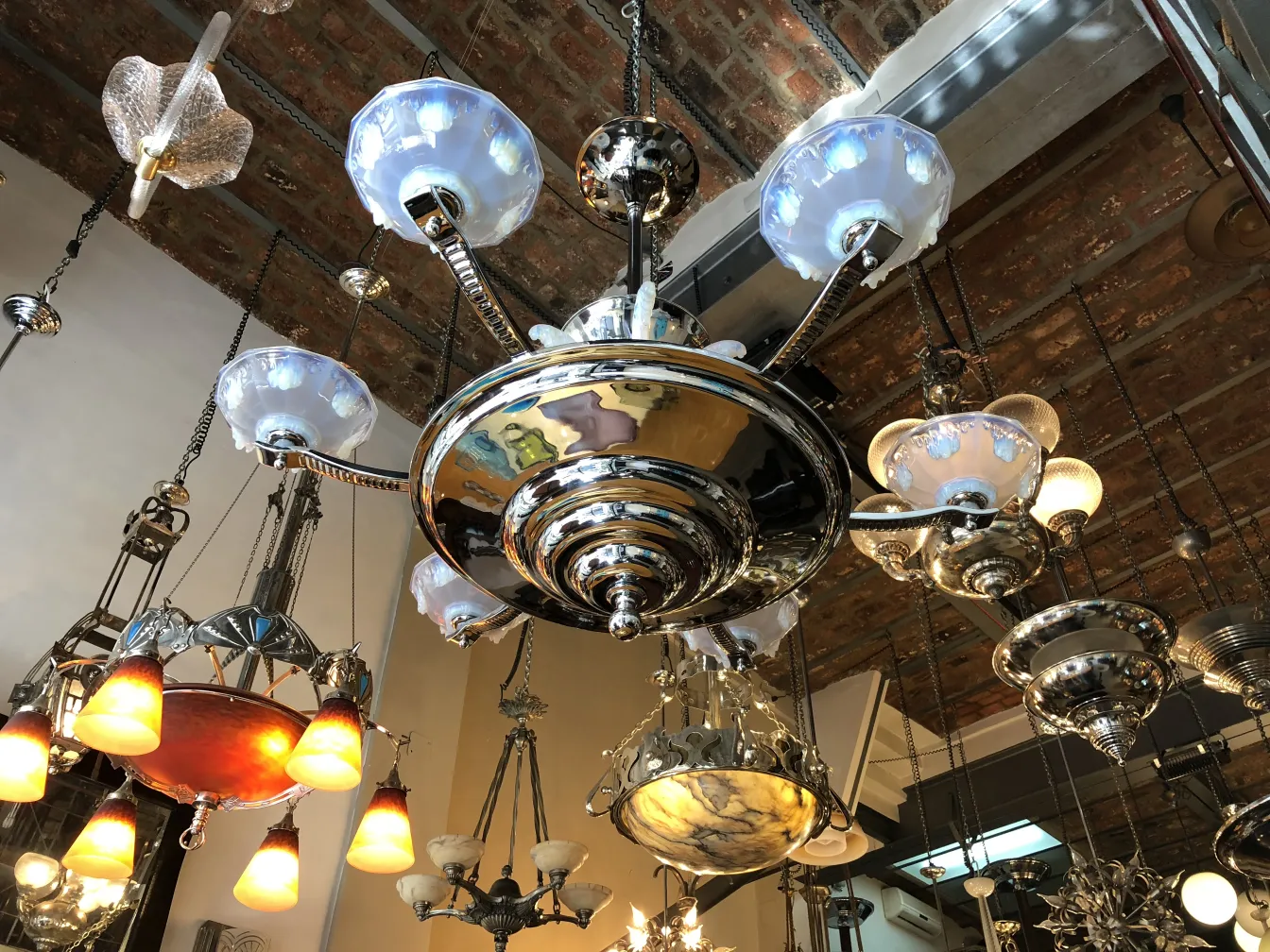 Antique hanging lamp with opaline glass details, glowing elegantly.