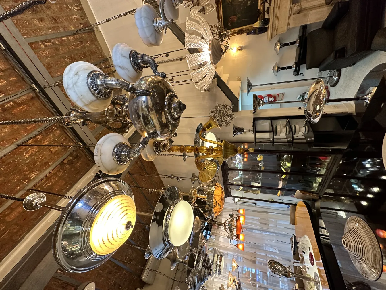 Various antique hanging lamps displayed under a round ceiling.