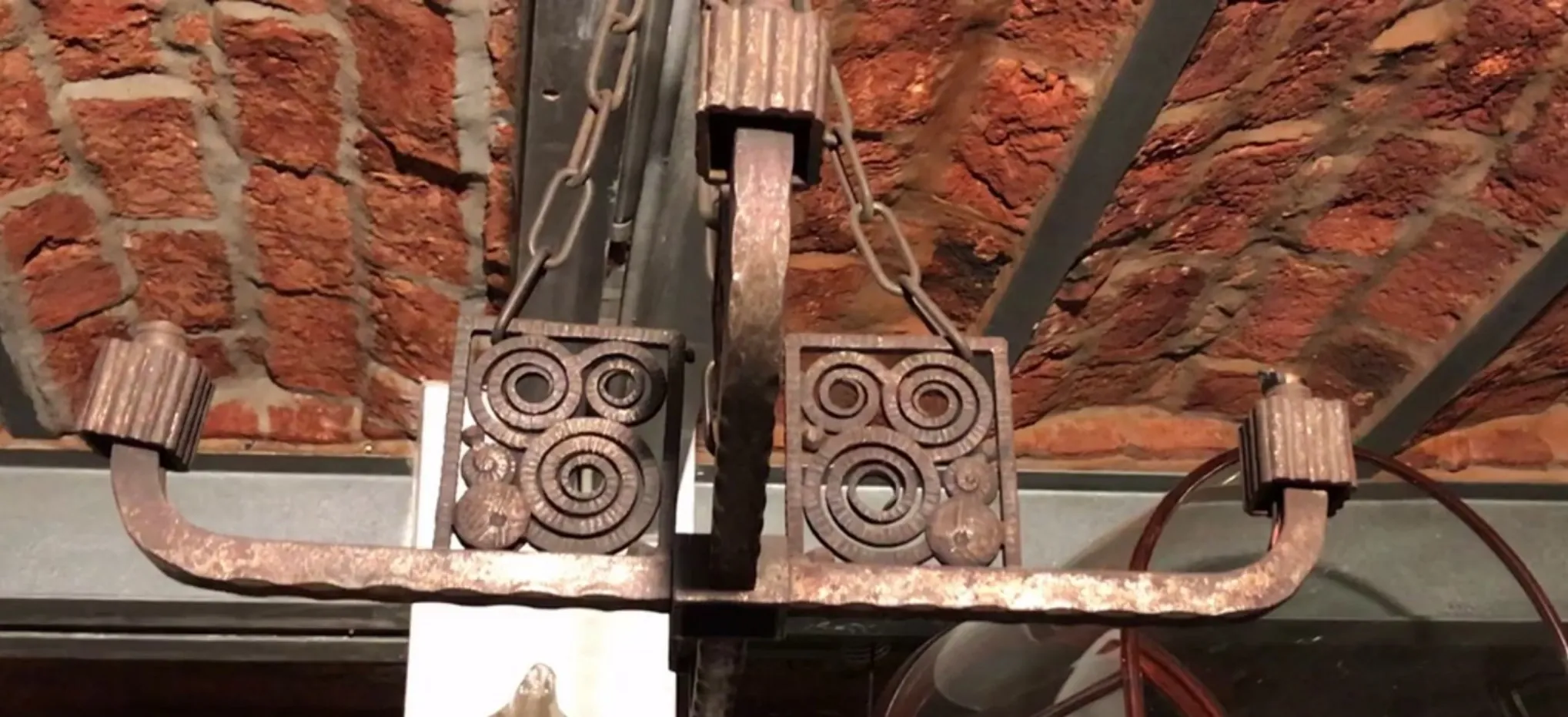 antique hanging lamp with decorative design in a rustic setting