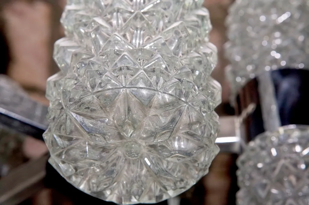 Antique hanging lamp with a sparkling, faceted design, adds elegance to any space.