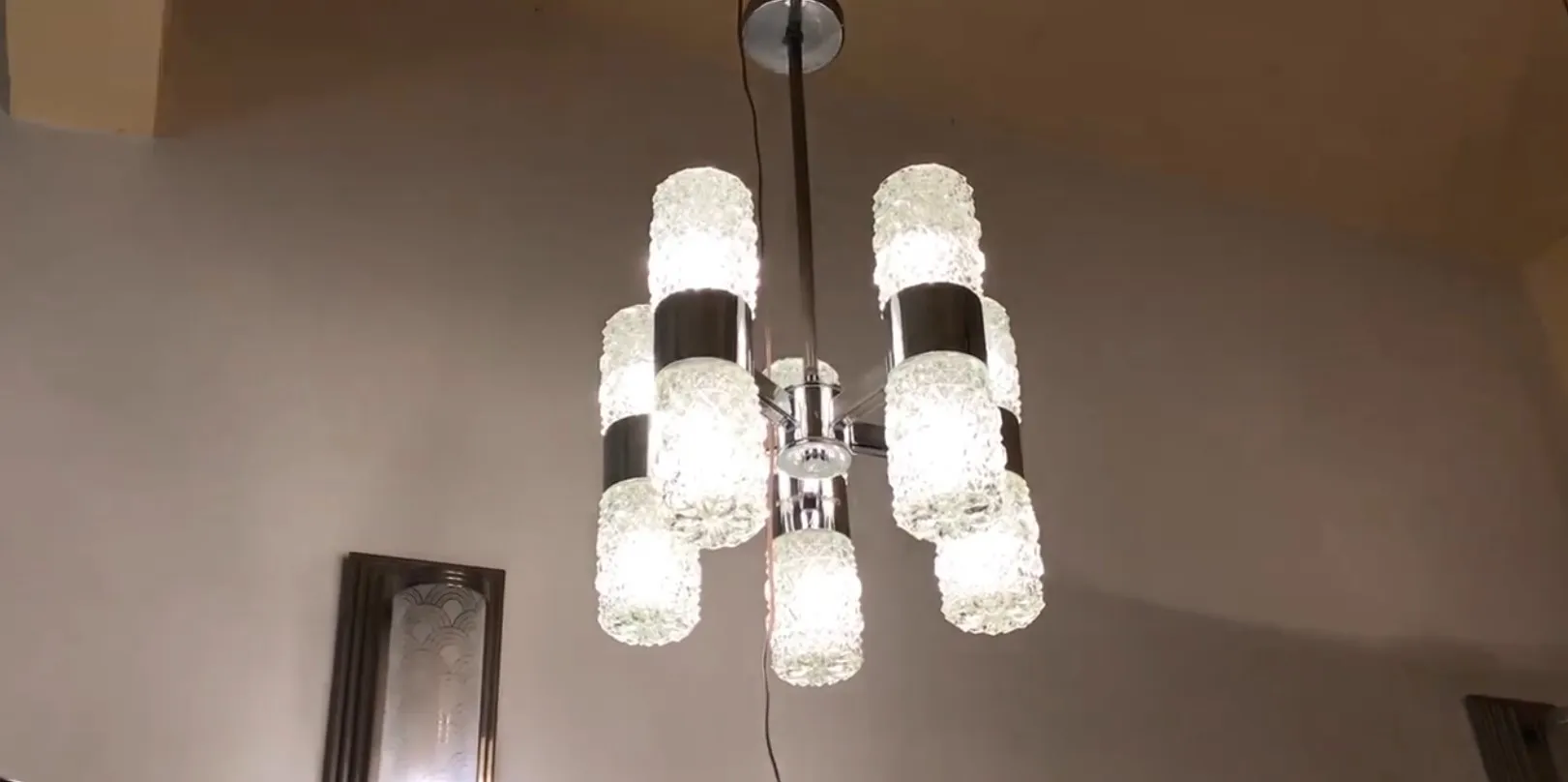 Antique hanging lamp with bright lights, decorative features.