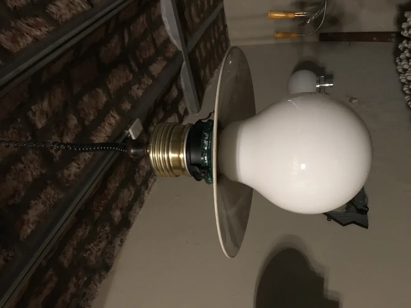 Purani latakne wali lamp jismein safed bulb hai.