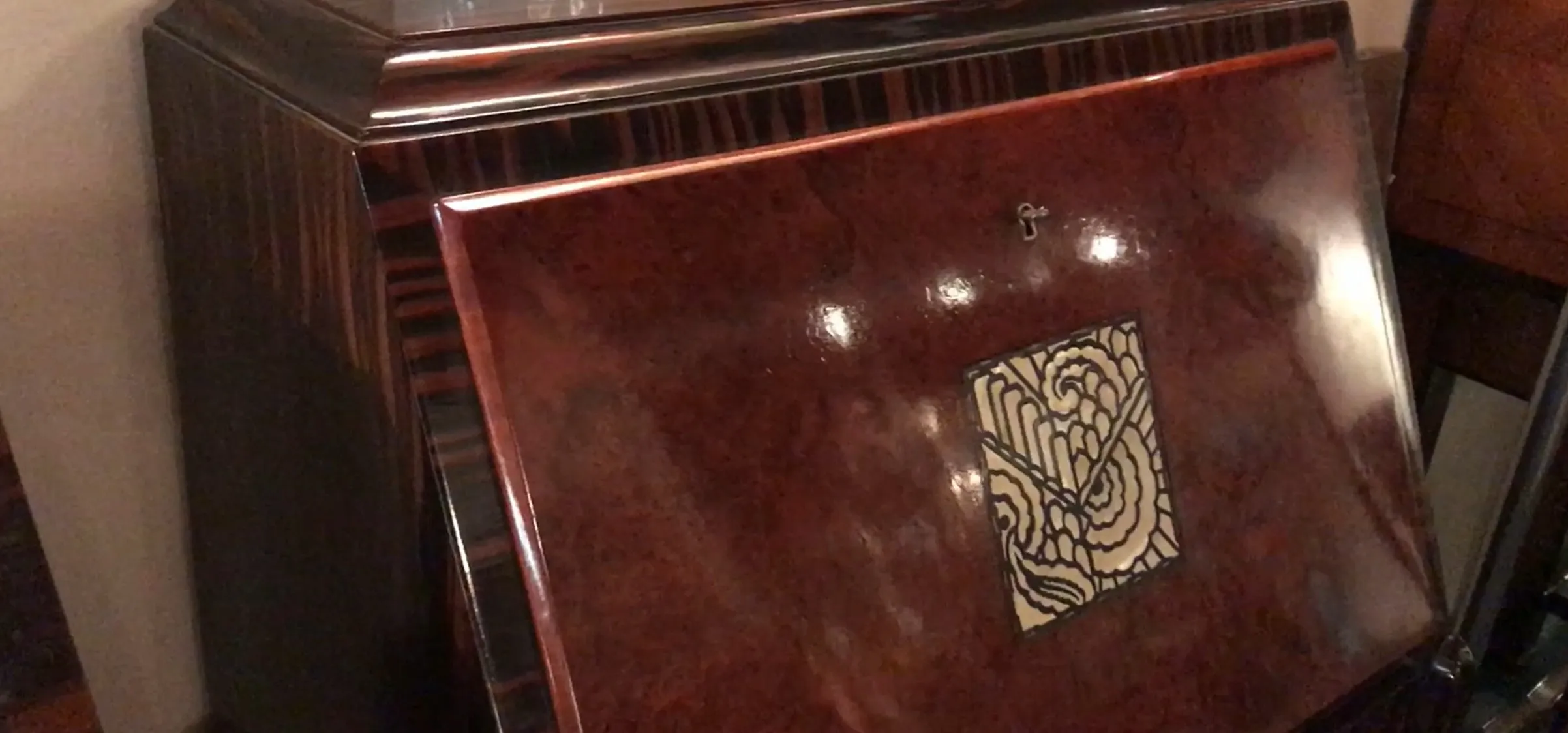 antique desk with detailed design on the front, warm atmosphere