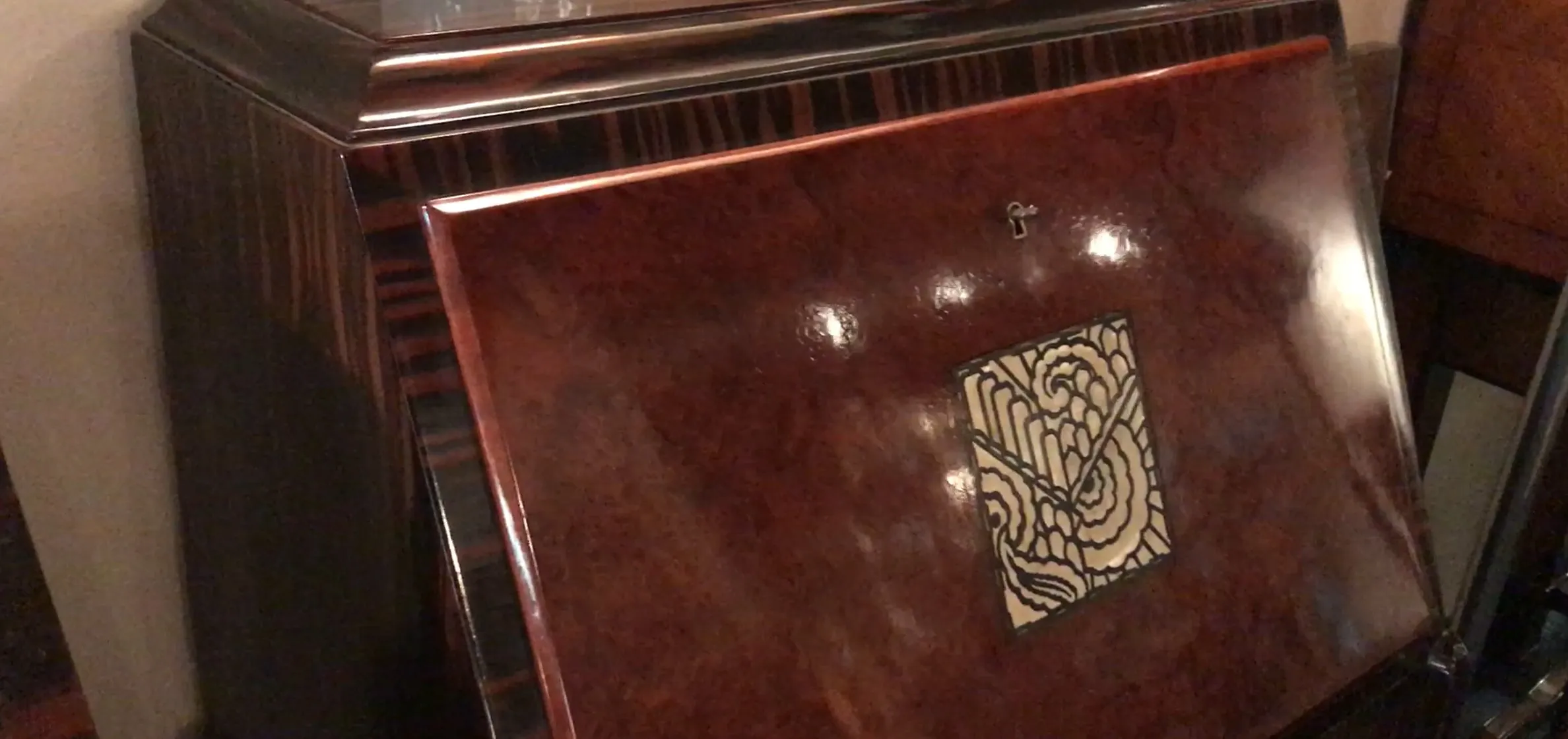 Antique wooden desk with decorative design on the top, classic atmosphere.