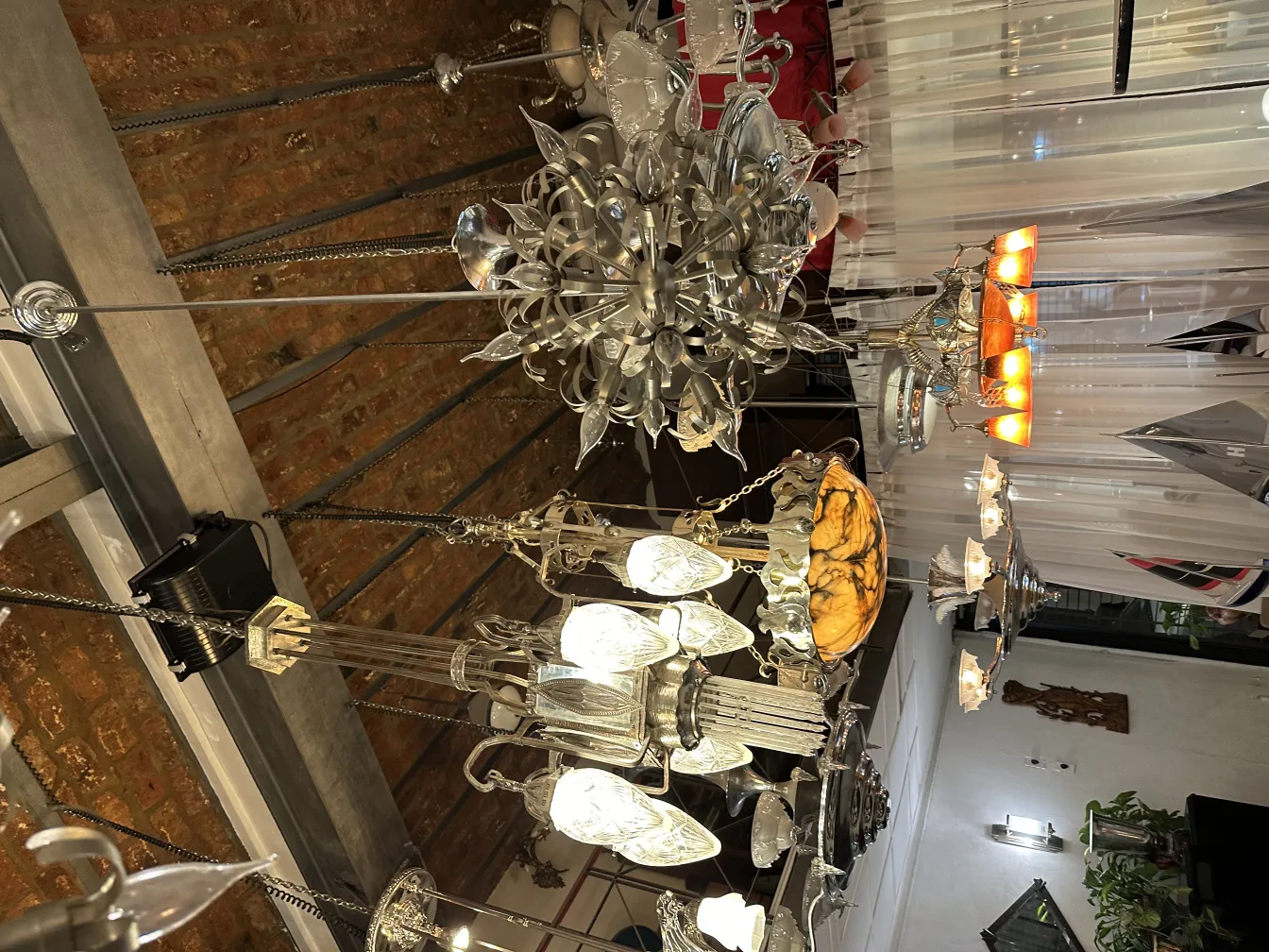 Antique hanging lamp with elegant decorative designs in a cozy setting.