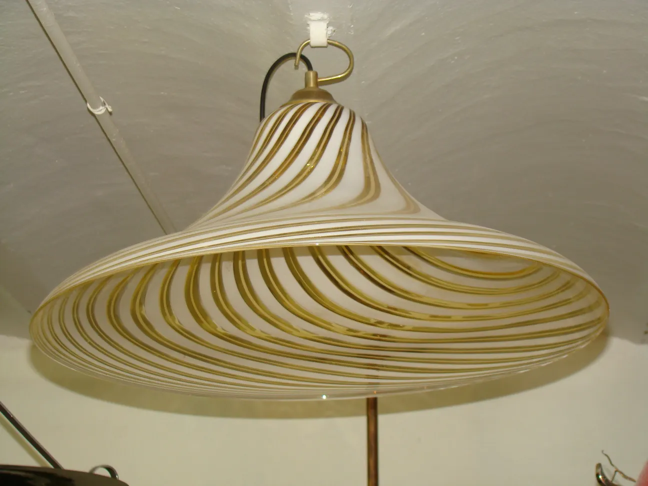 Antique hanging lamp featuring geometric designs with a glossy finish.