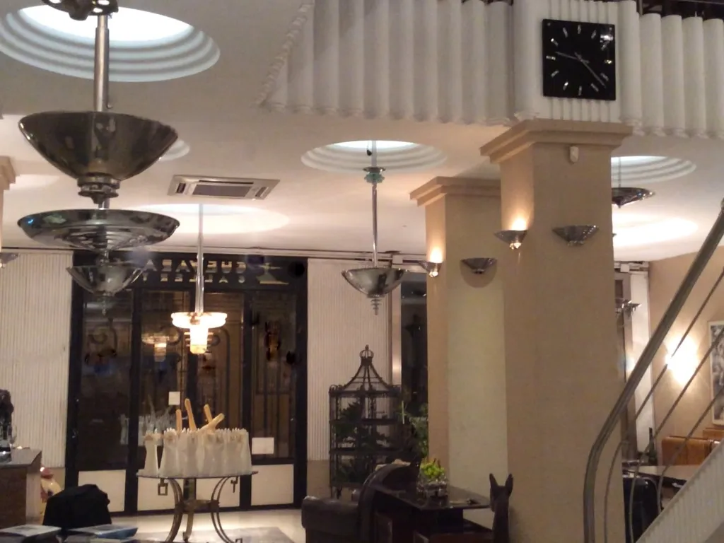 Antique hanging lamp in an elegant restored modernist setting.