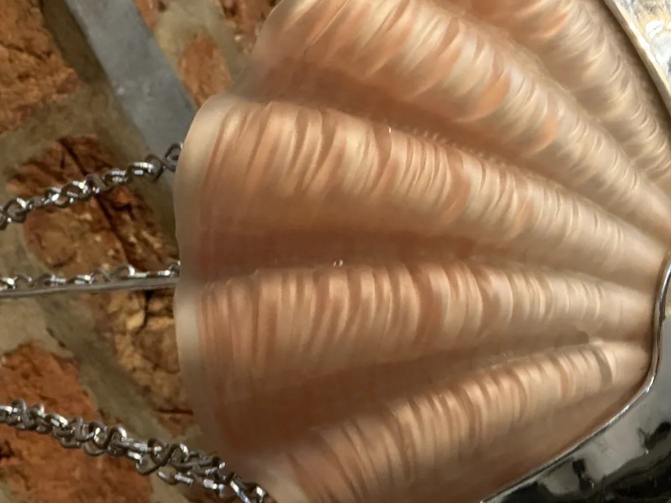 Antique hanging lamp with shell design, warm ambiance.