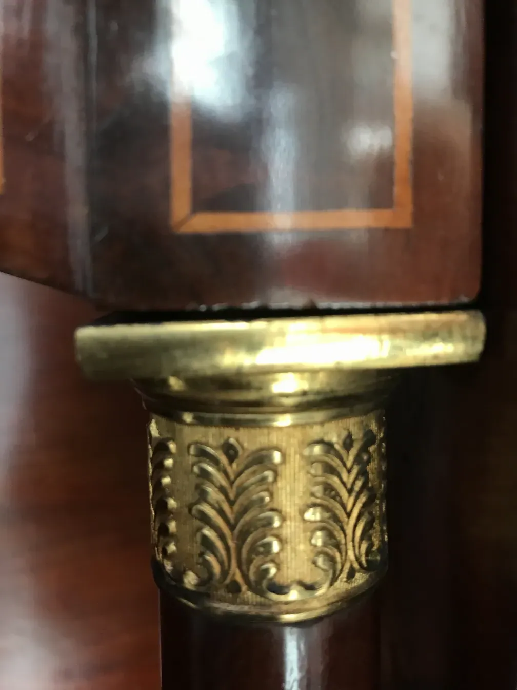 Golden details on an antique desk with a polished finish.