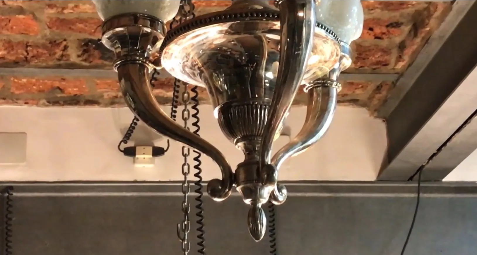 Antique hanging lamp with an elegant and decorative design, suspended in a cozy environment.