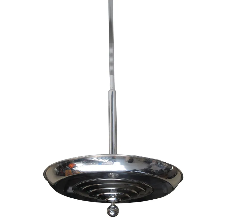 Lampada a sospensione antica con finitura lucida e design elegante in un ambiente minimalista.