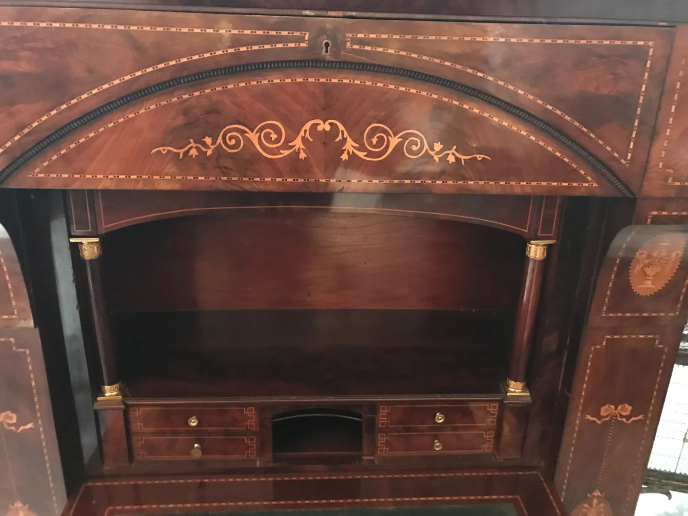 Antique desk featuring beautiful decorative details.