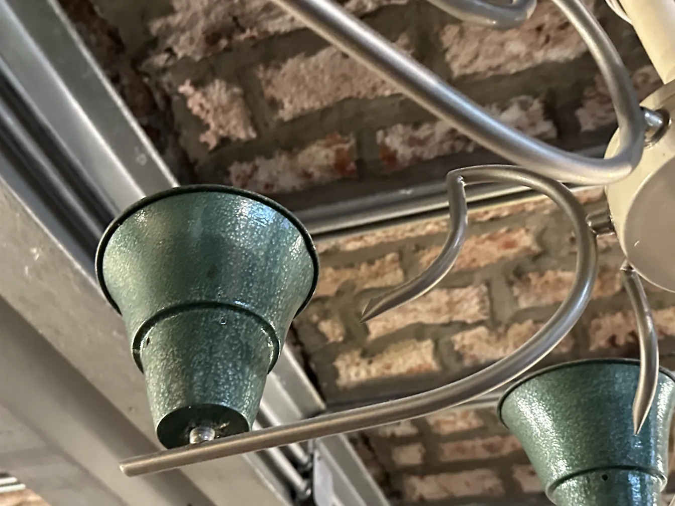 Antique hanging lamp with green cups in elegant design.