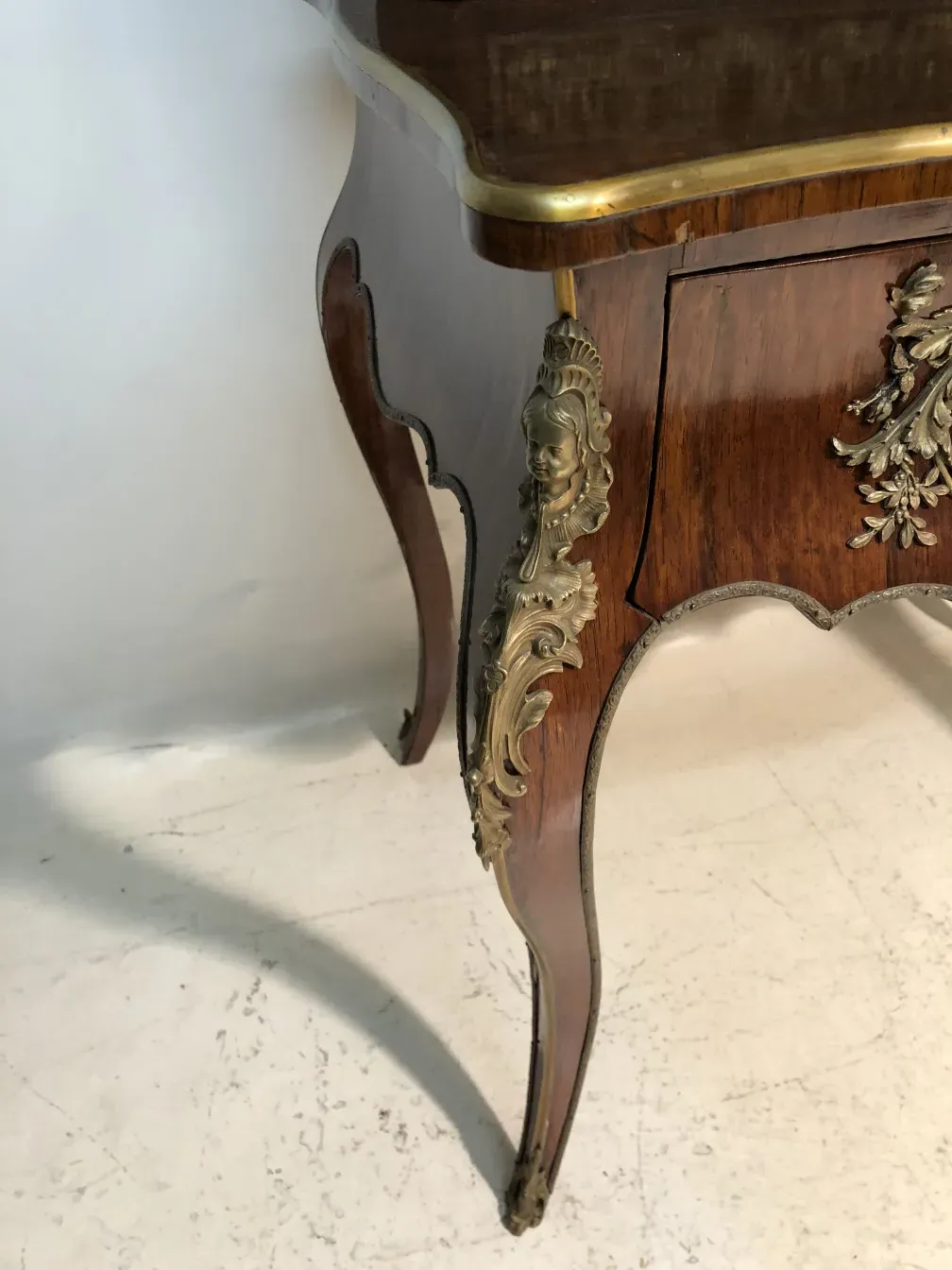 Antique wooden desk with golden ornaments.