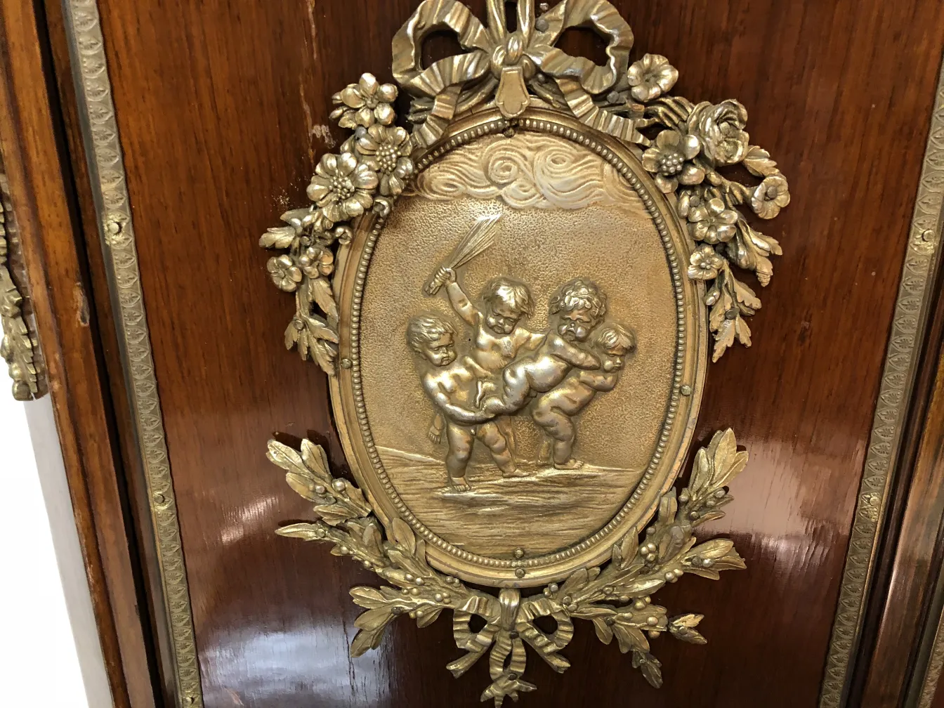 antique desk with ornate golden decoration and relief of children
