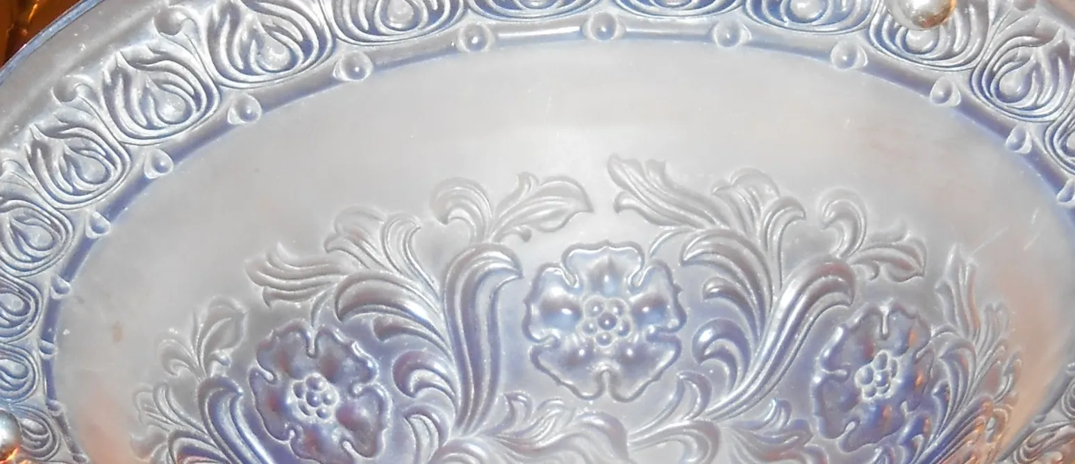 Antique hanging lamp with floral design on the edge.