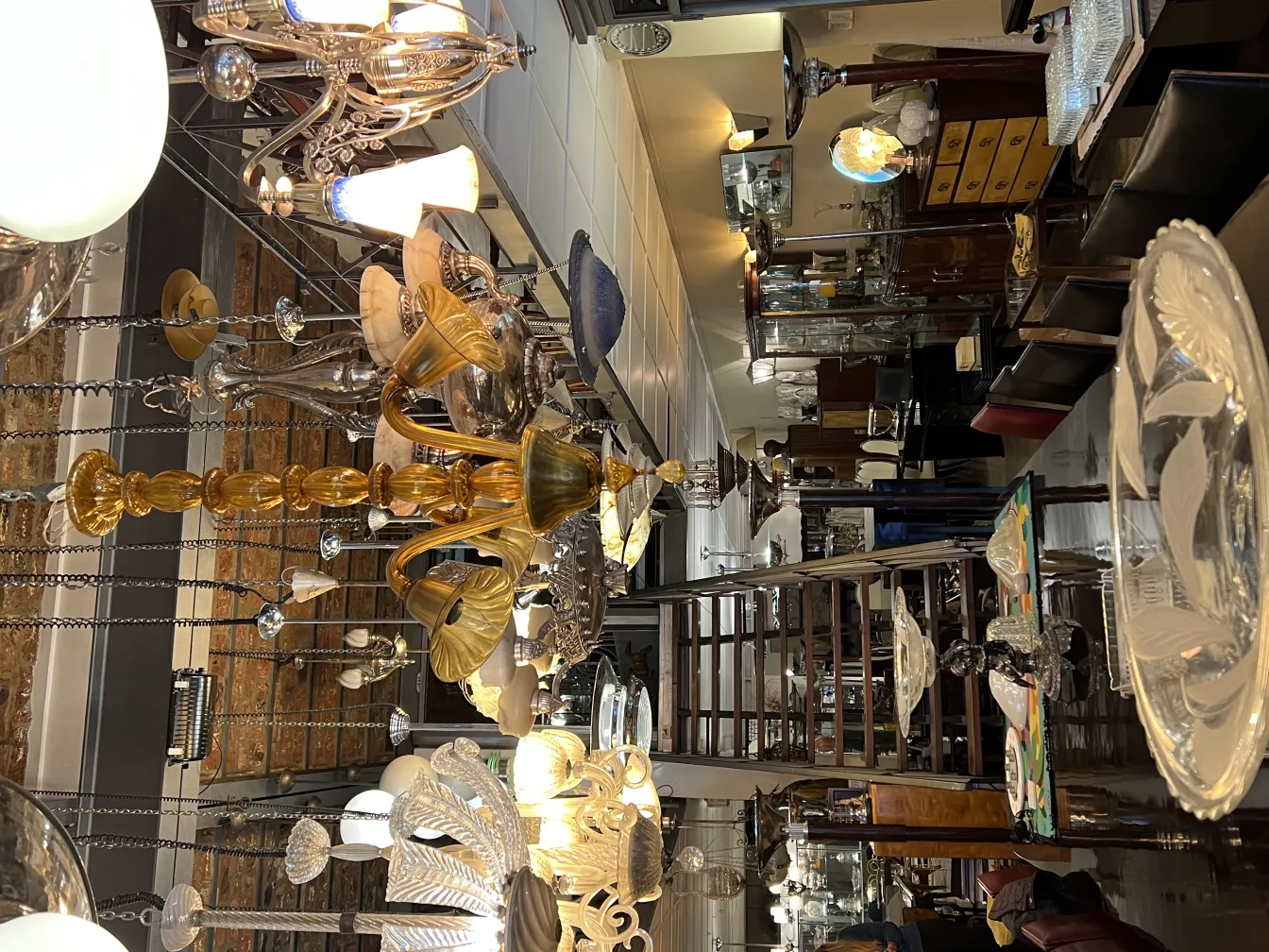 Antique hanging lamp with an intricate design, surrounded by vintage decor.