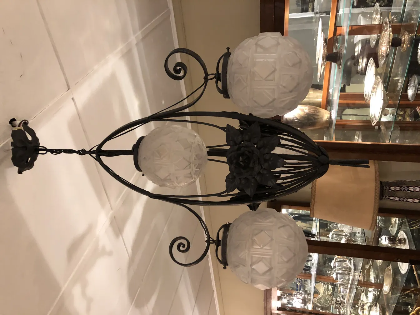 Antique hanging lamp with frosted glass spheres, elegant ambiance.