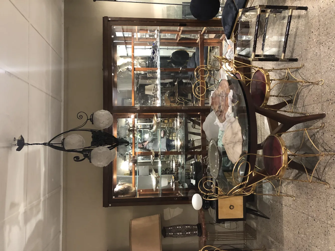 Antique hanging lamp with three white globes, elegant setting.