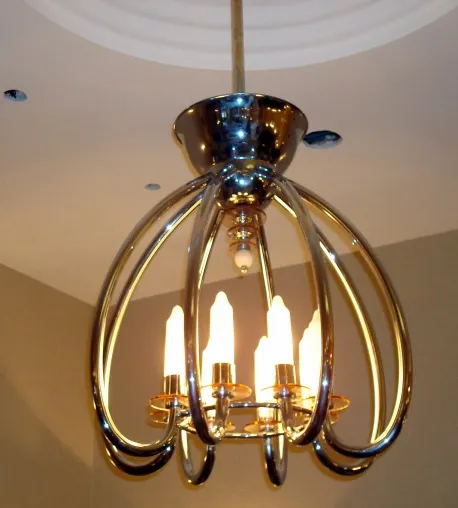 Antique hanging lamp with elegant design and multiple glowing bulbs, illuminating the surroundings.