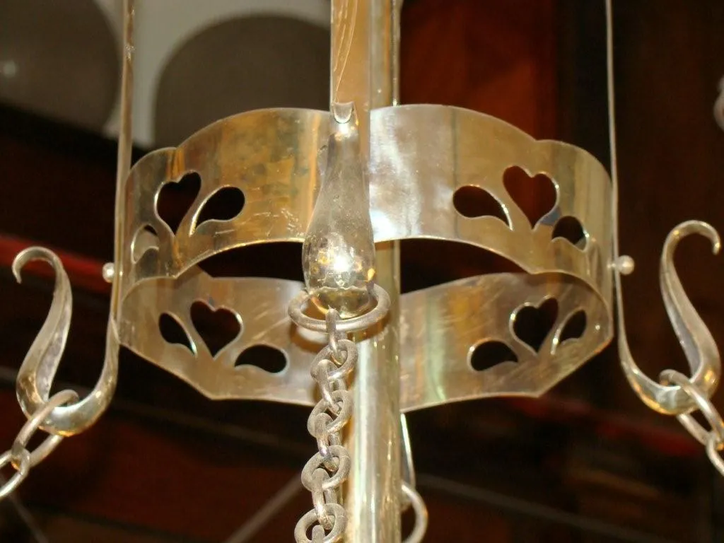 Antique hanging lamp with heart-shaped details. Warm and cozy atmosphere.