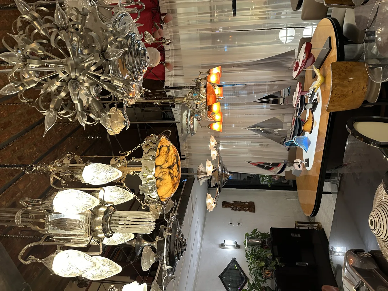 Beautiful antique hanging lamp with crystal and metal details in a modern setting.