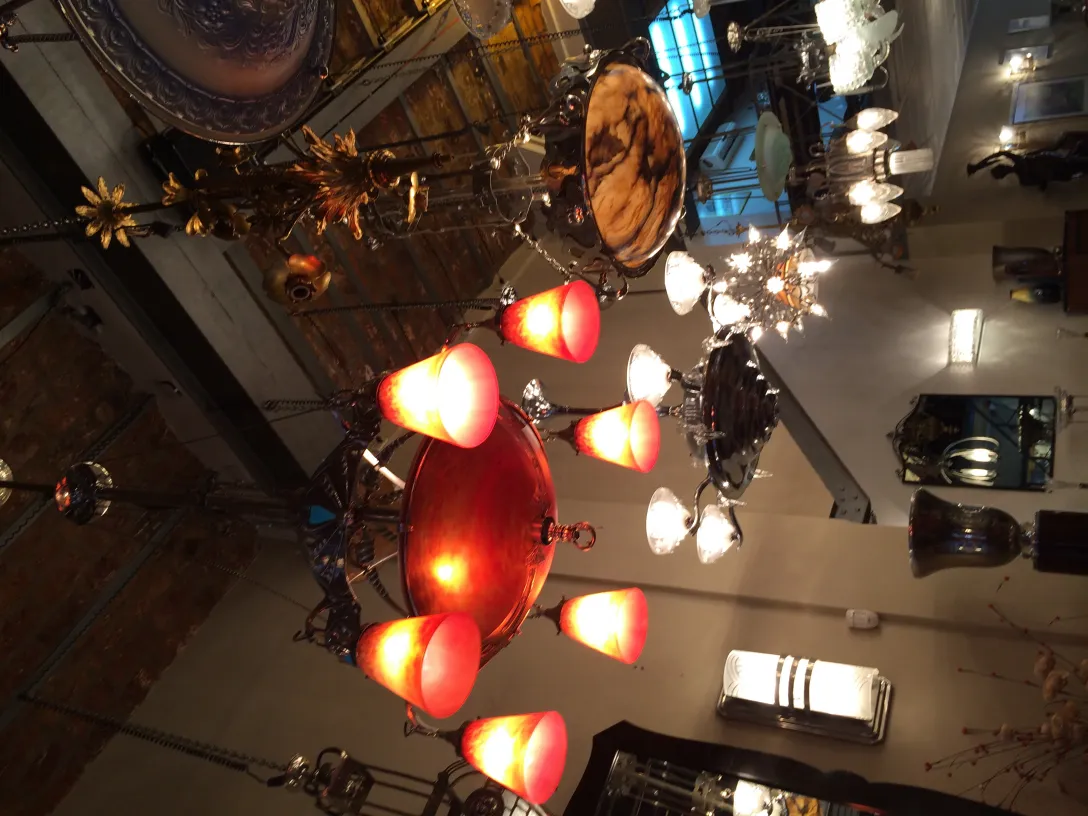 Antique hanging lamp with red lights illuminating the surroundings. Other decorative elements visible.