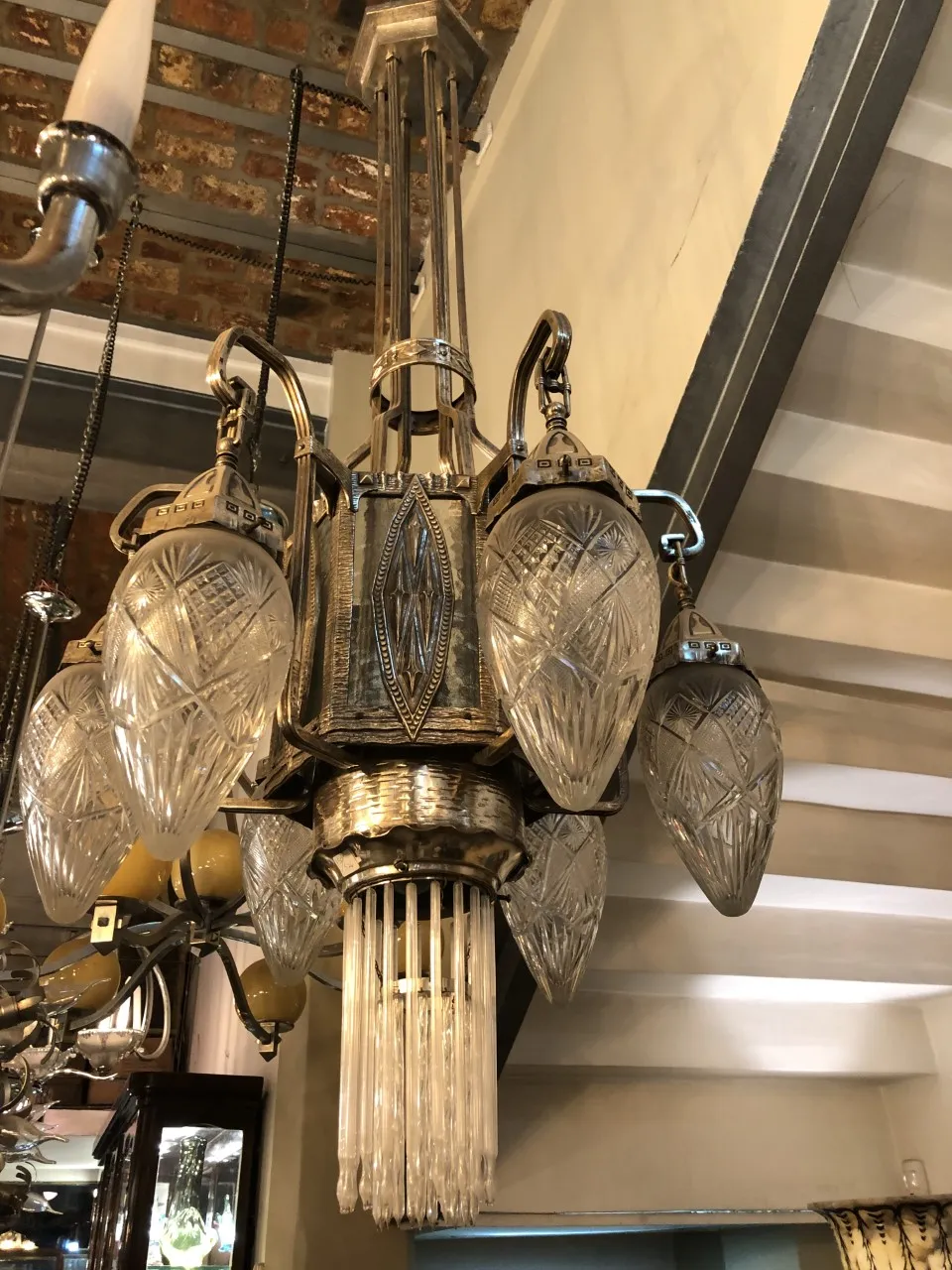 Antique hanging lamp with crystal details and an elegant design, set in a warm interior.