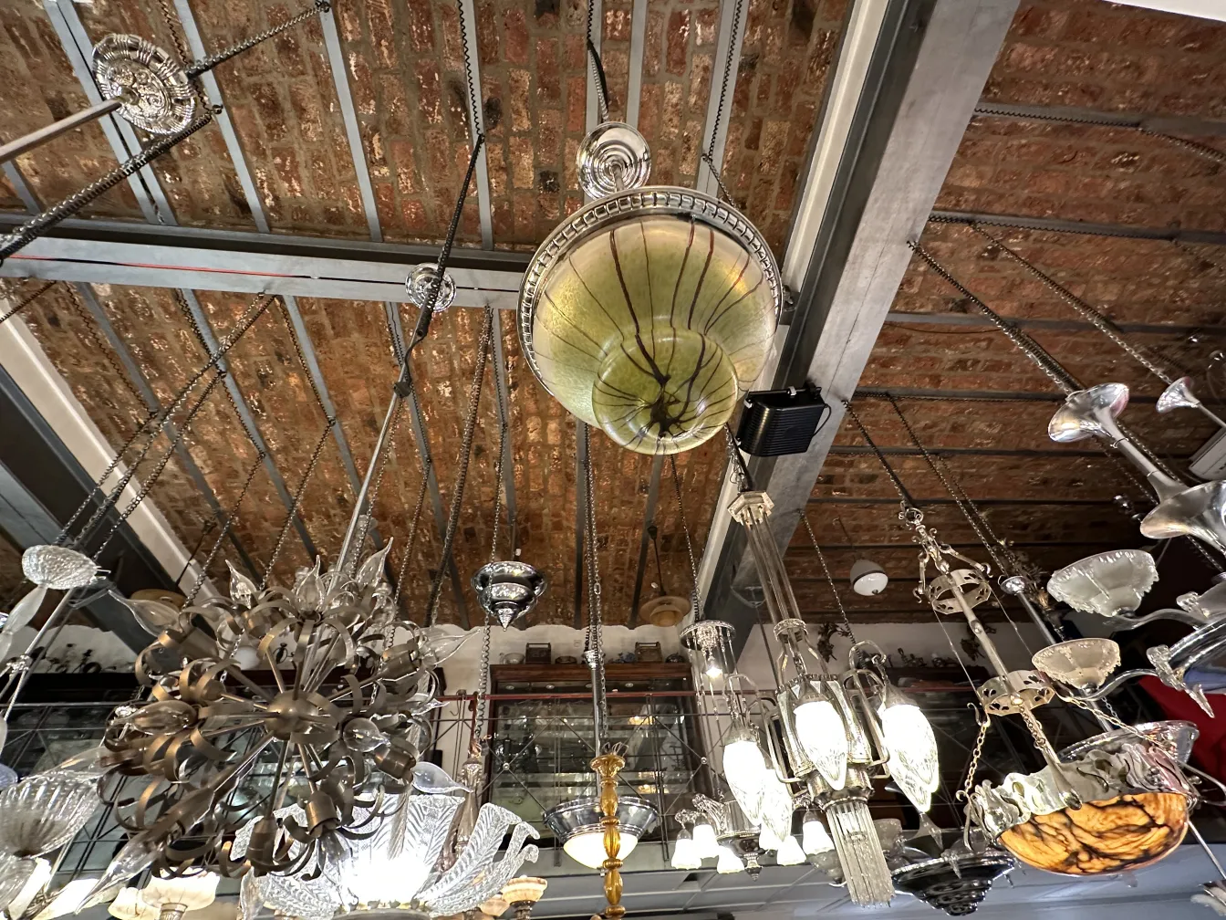 Antique hanging lamp with a distinctive design, suspended in a setting with other light fixtures.