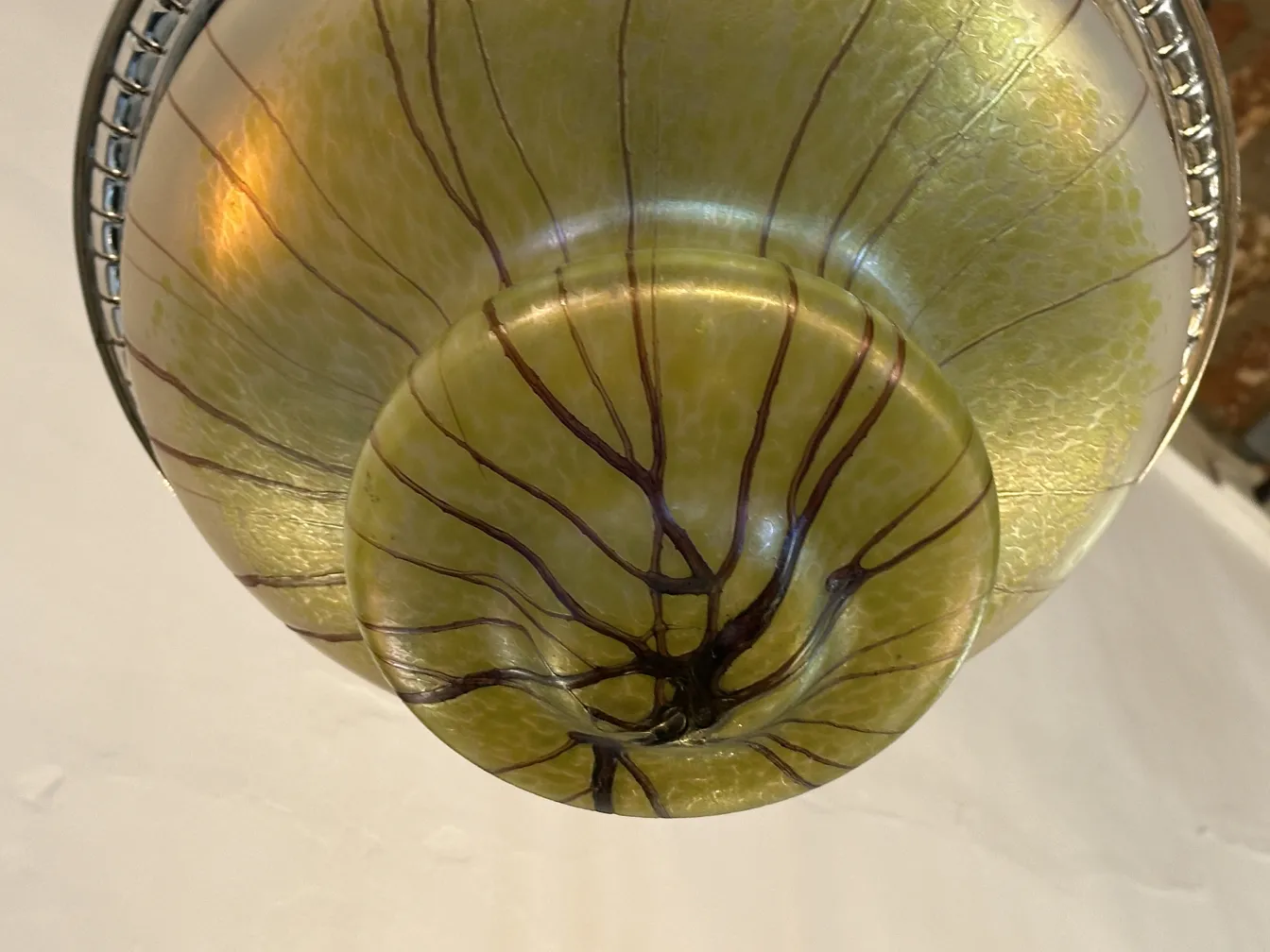 Antique hanging lamp with yellow and brown abstract designs, elegant and artistic.