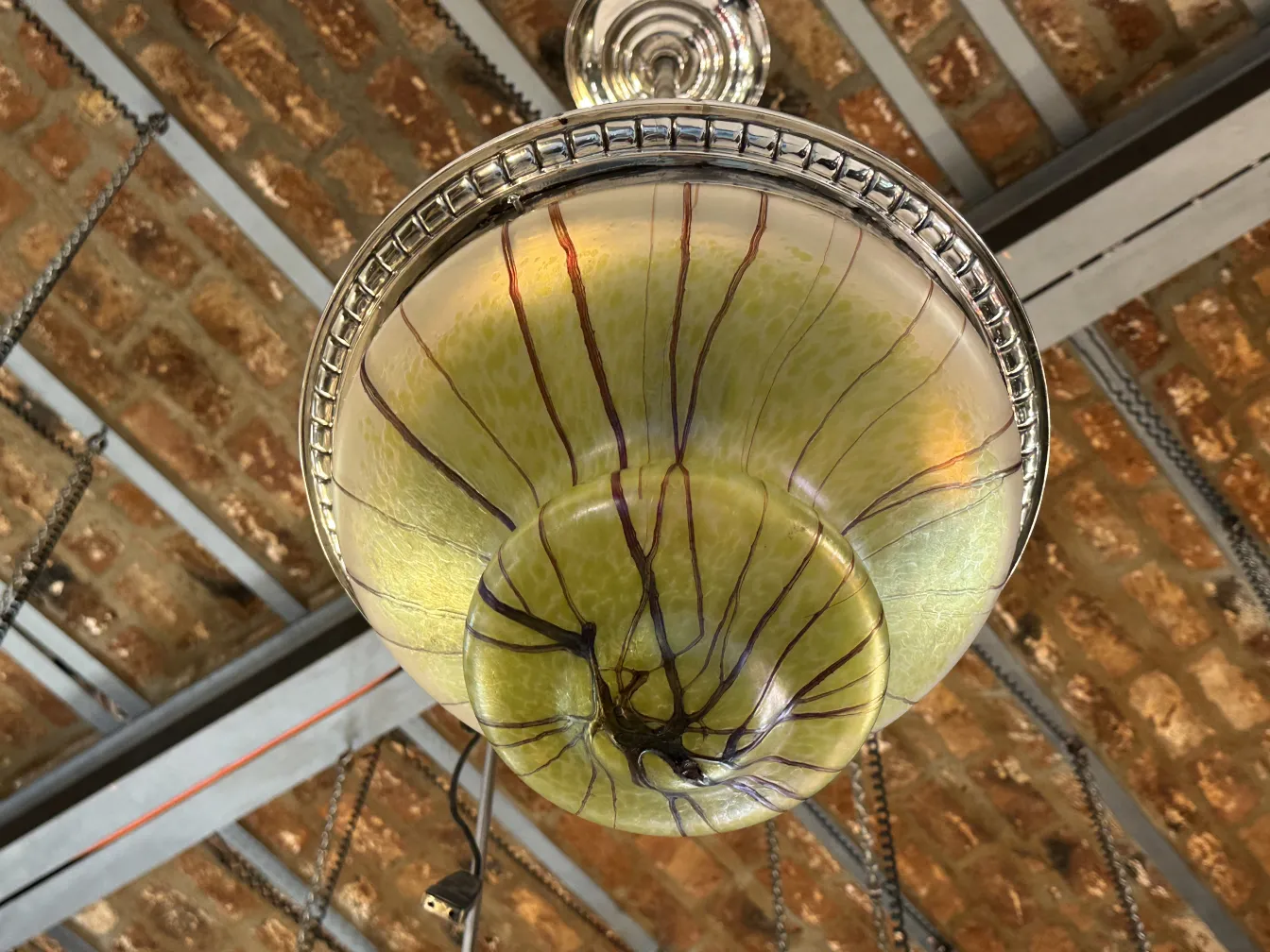 Antique green hanging lamp with brown line details, perfect for decoration.