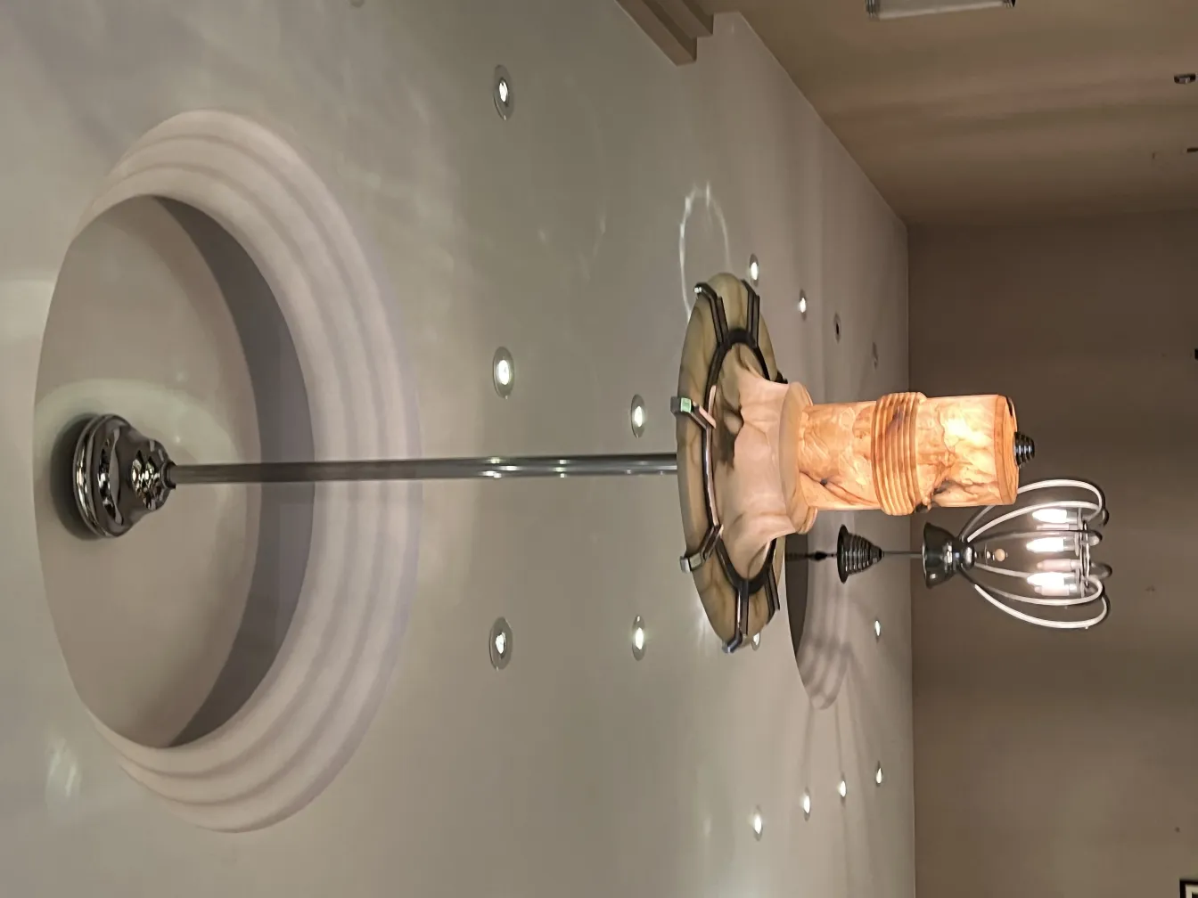 Antique hanging lamp with a unique design, surrounded by soft ambient lighting.