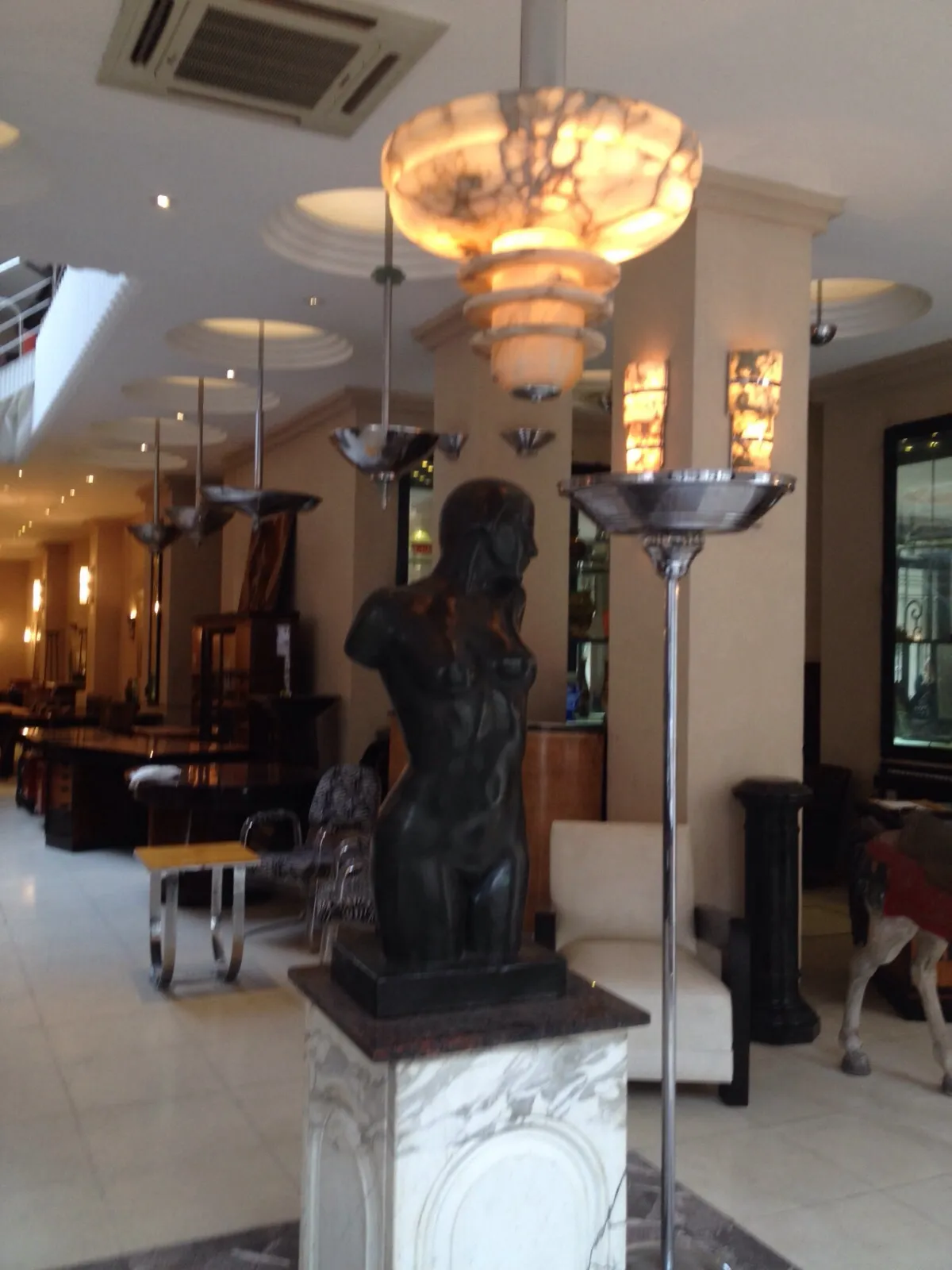 Antique hanging lamp with elegant design illuminating a modern space.