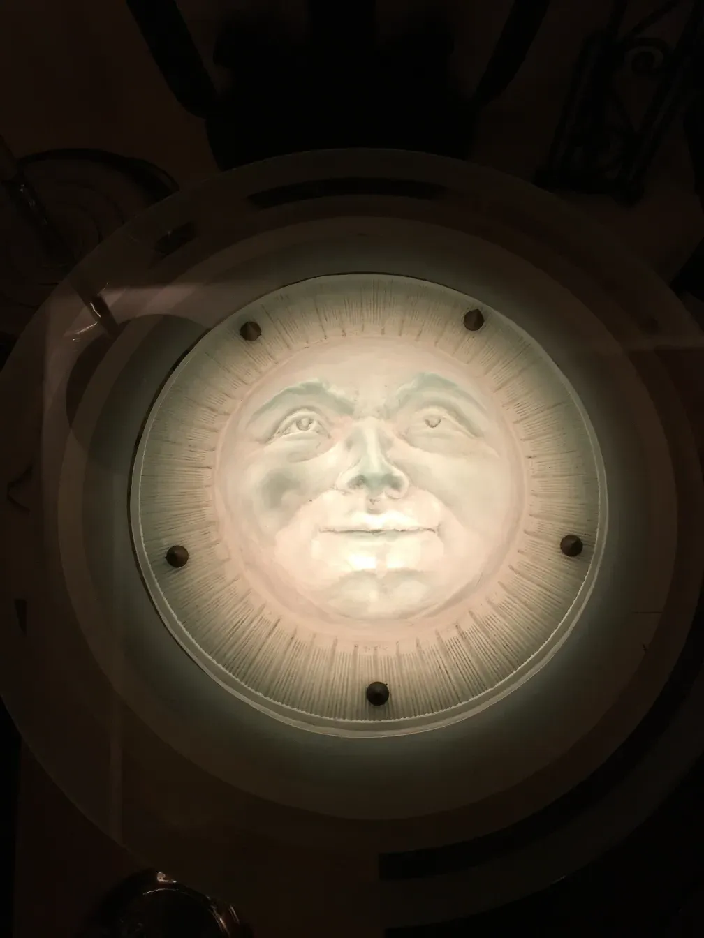 lampada de teto antiga estilo St Louis com rosto do sol iluminado