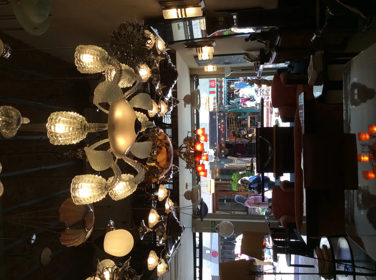 Antique hanging lamp with bright lights in a cozy setting.