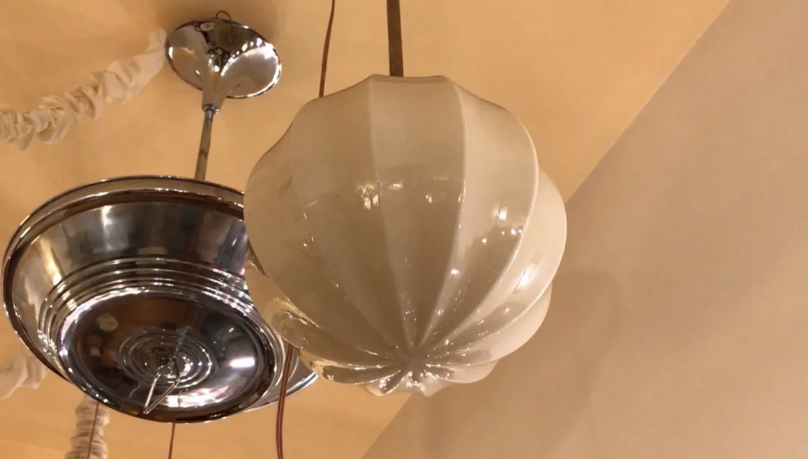 Antique glass hanging lamp, elegant and shiny, in a cozy setting.