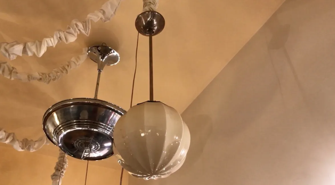 Antique hanging lamp with white globe in a stylish setting