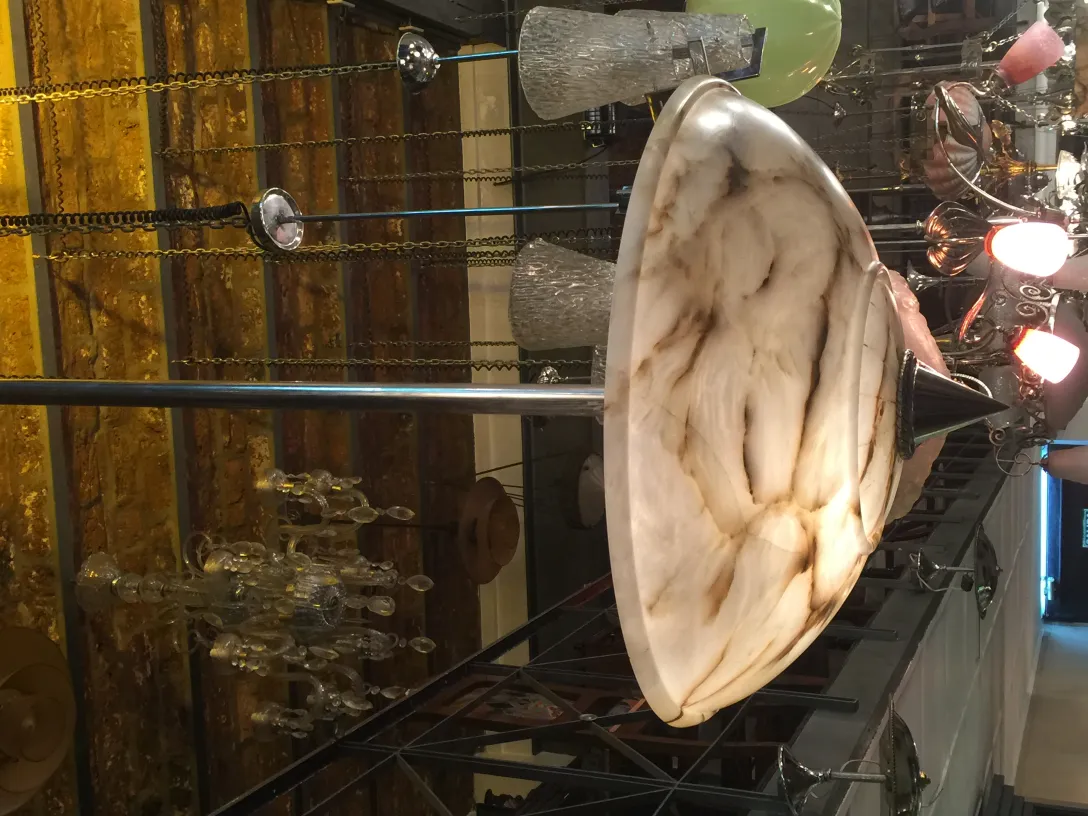 Antique hanging lamp with an elegant design, in a cozy setting with other decorative objects.