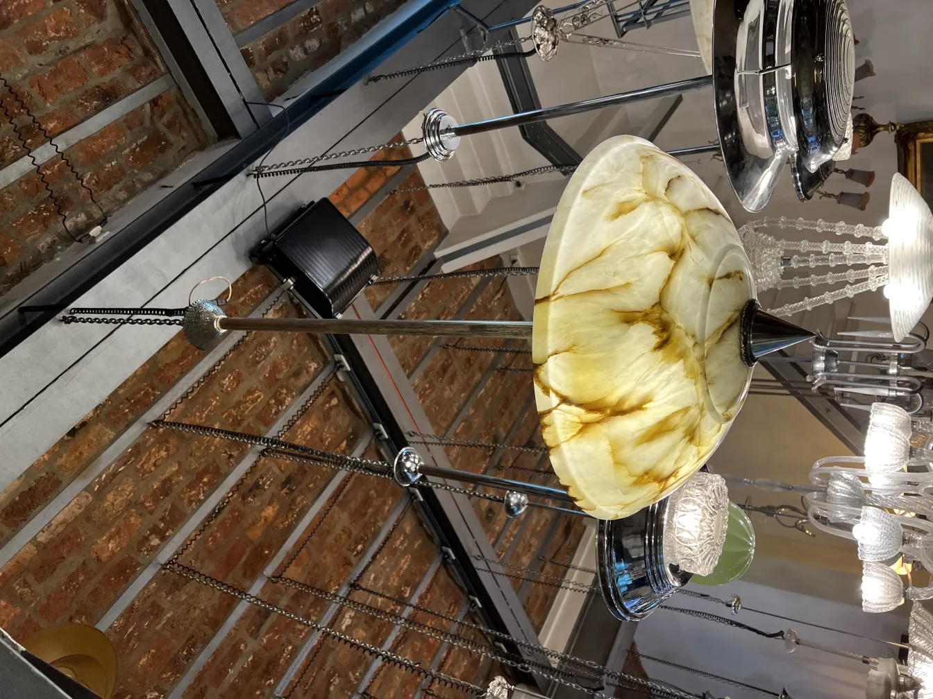 Antique hanging lamp with yellow glass in an elegant setting.