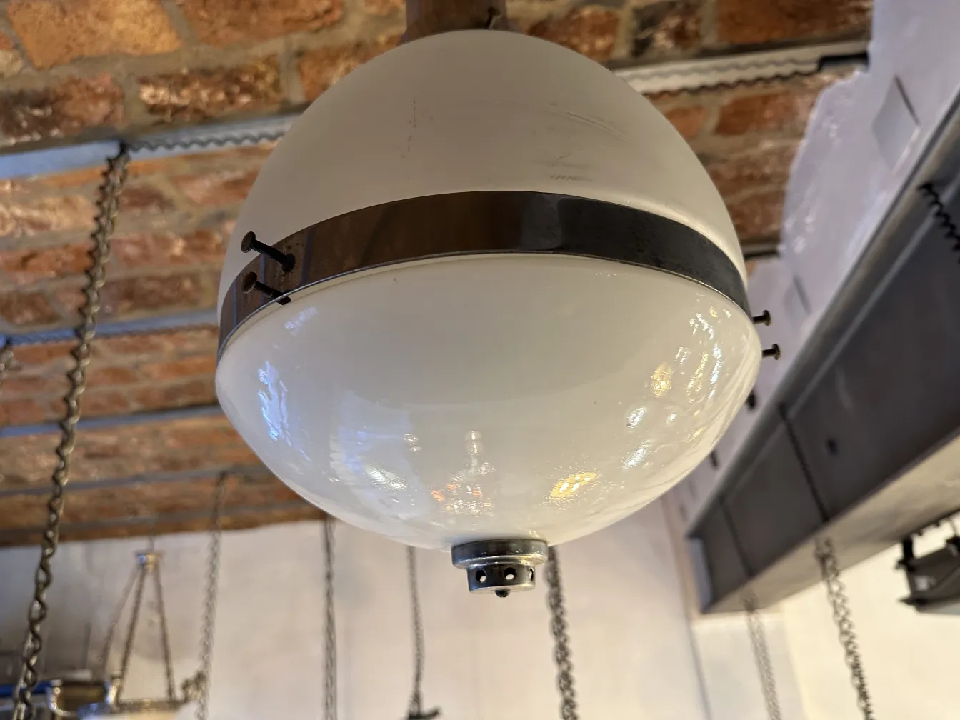 Antique hanging lamp with a spherical glass design, suspended from the ceiling.