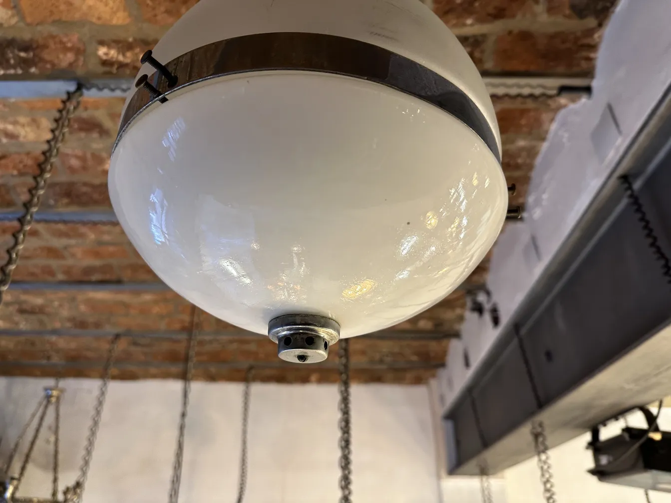 Antique white hanging lamp with metallic details in a cozy setting