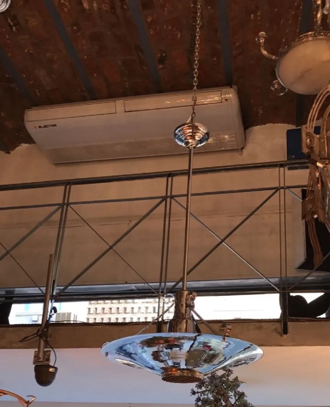 Shiny antique hanging lamp in an elegant setting, with metallic details.