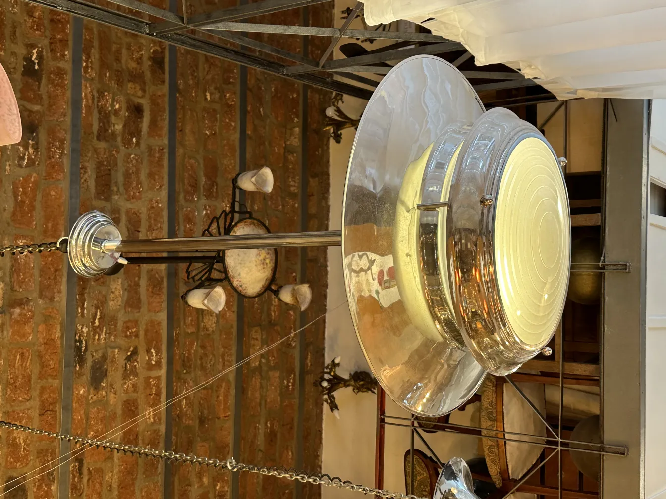 Shiny hanging lamp in vintage setting with brick wall