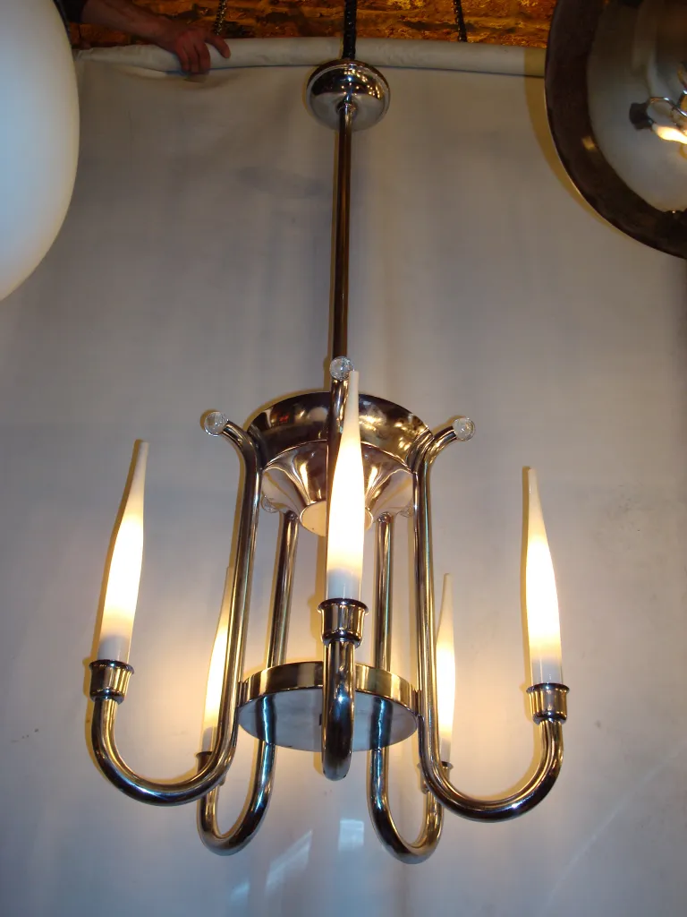 Antique hanging lamp with stylized arms and white lights