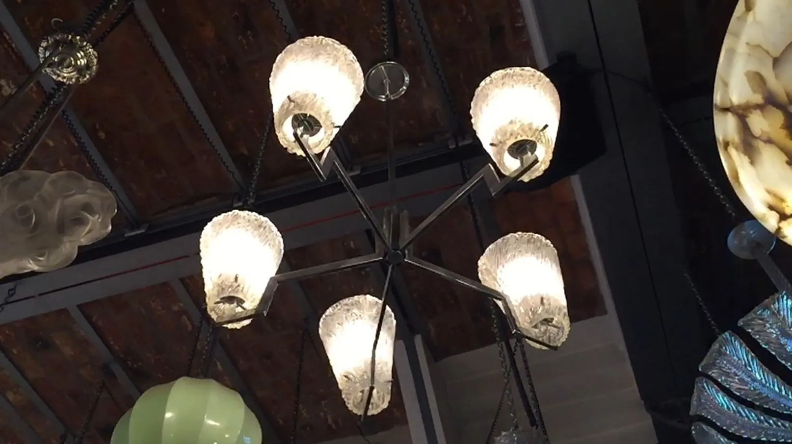 Antique hanging lamp with glass shades and soft light.