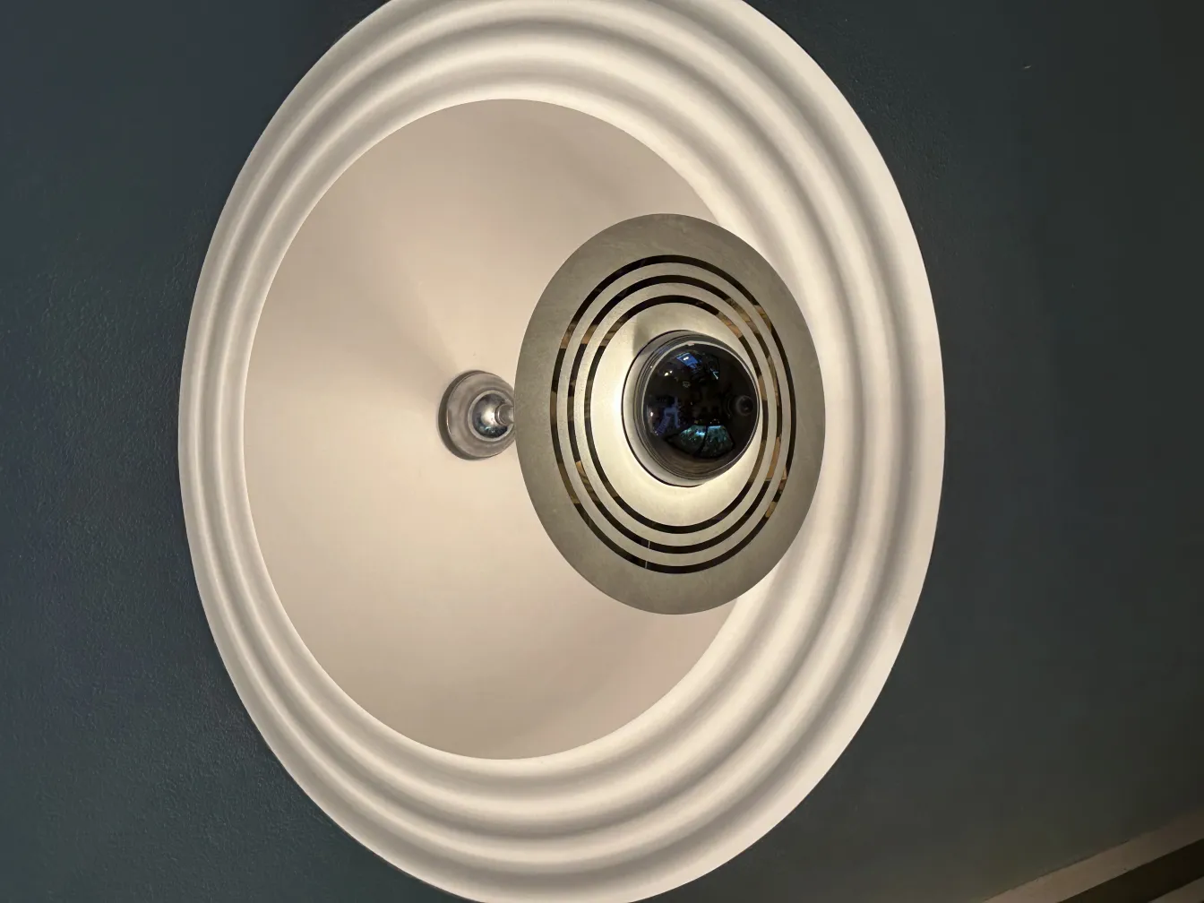 Antique hanging lamp in a modern setting with subtle details.